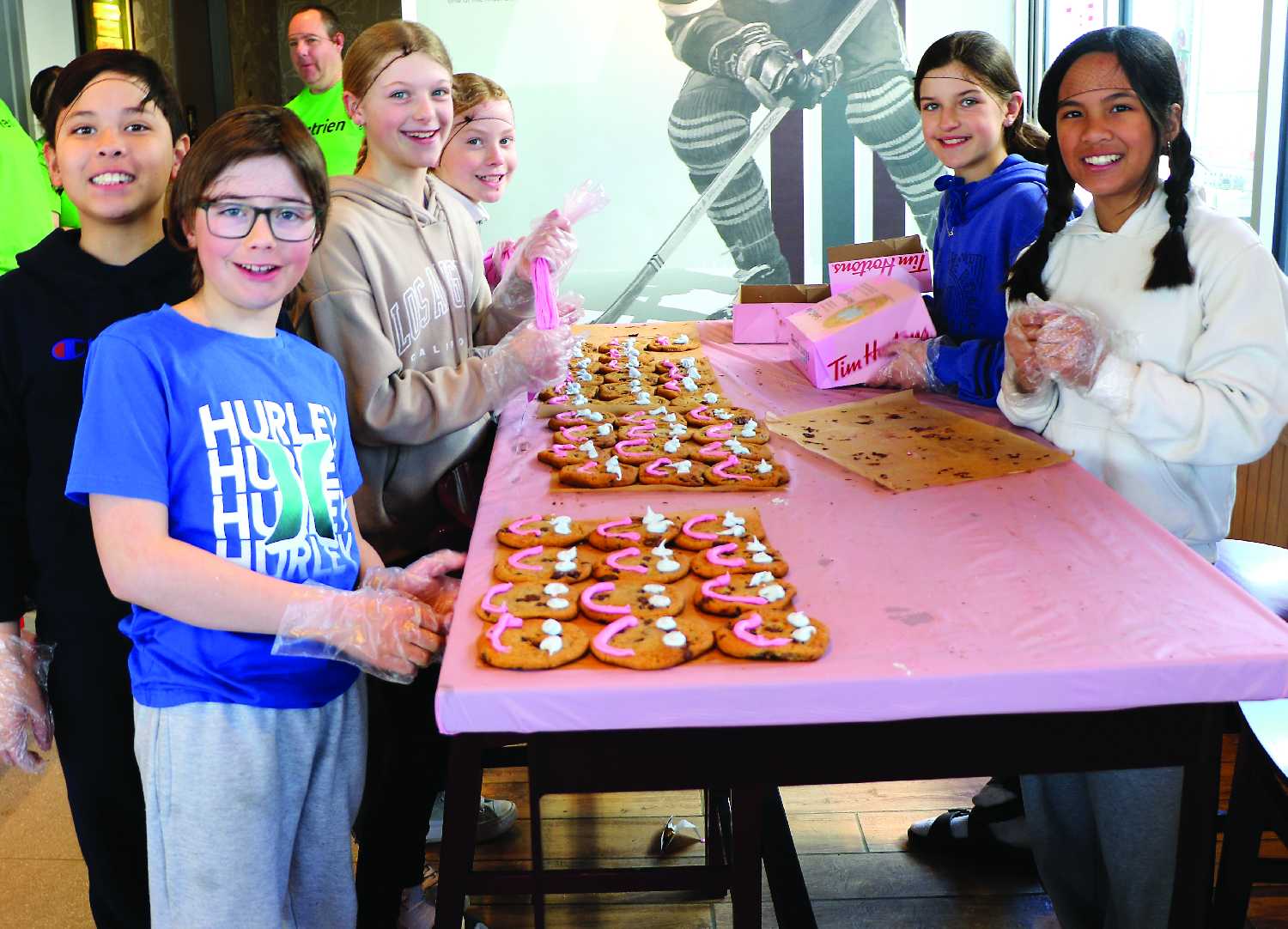 MacLeod Elementary School students volunteering to decorate Smile Cookies.